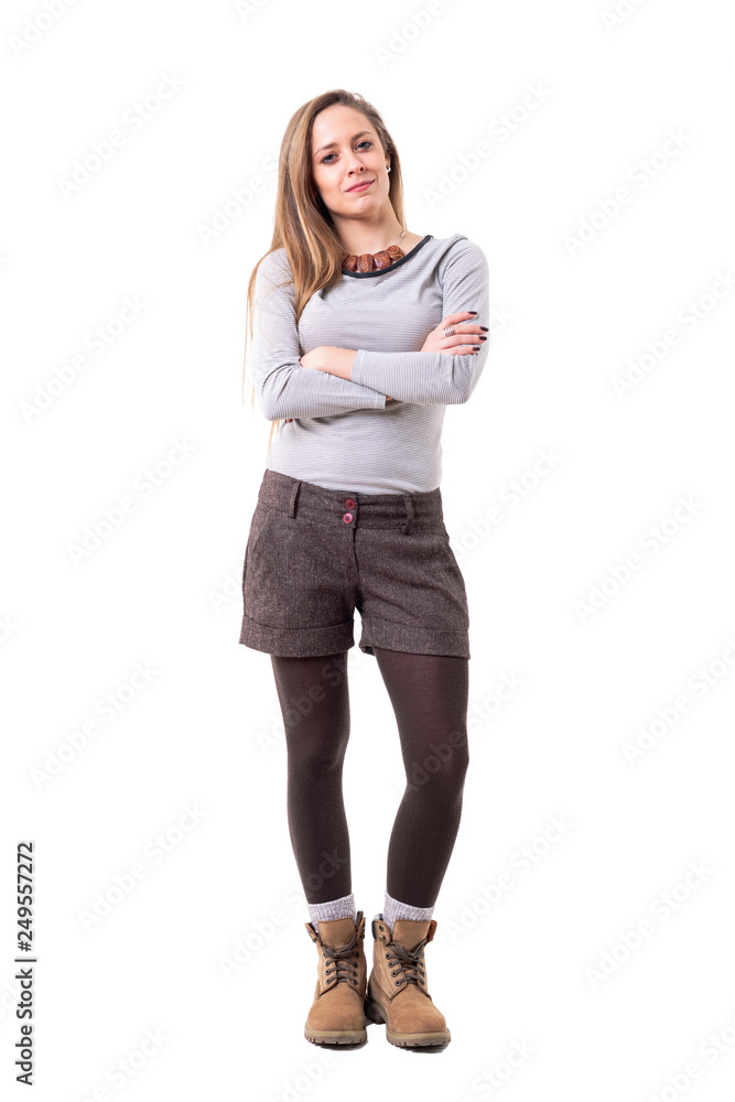 Pretty young unconvinced woman with skeptical ironic smile looking at camera and frowning. Full body isolated on white background. Pretty young unconvinced woman with skeptical ironic smile looking at camera and frowning. Full body isolated on white background.