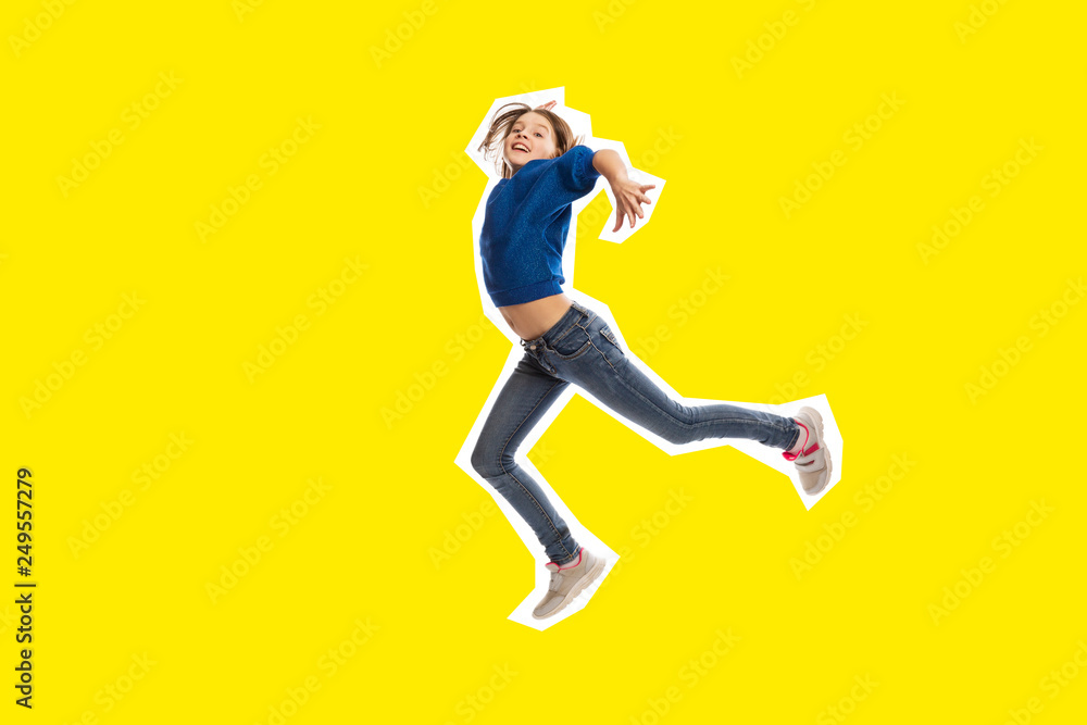 Cute teen girl in high jump, yellow  background