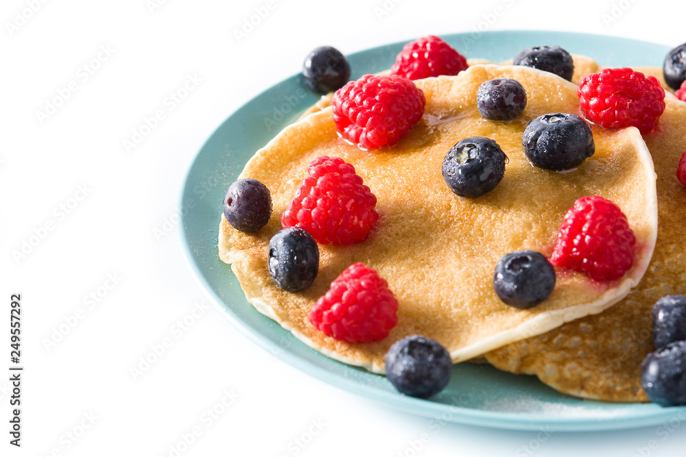 Pancakes with raspberries, blueberries and honey isolated on white background. Copyspace Pancakes with raspberries, blueberries and honey isolated on white background. Copyspace