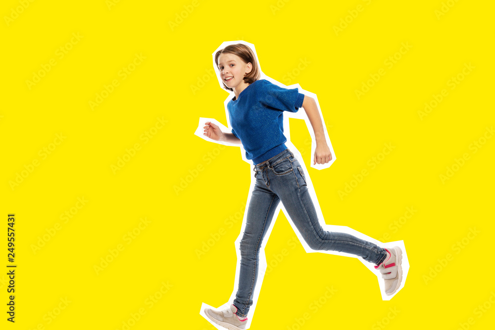 Running cute teen girl, yellow  background