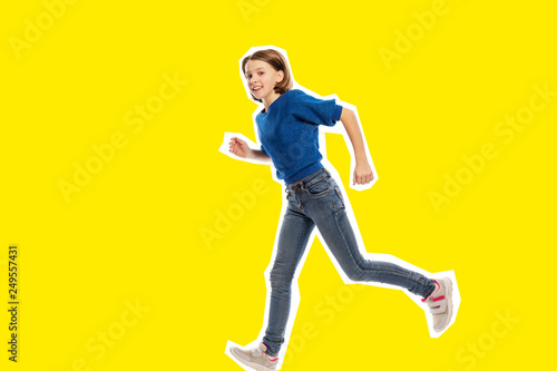 Running cute teen girl, yellow  background