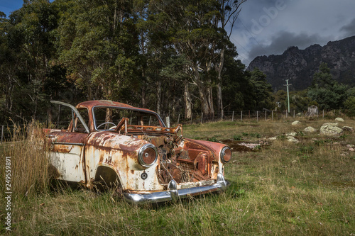Rusted vehicle in front of Mount Roland, Tasmania
