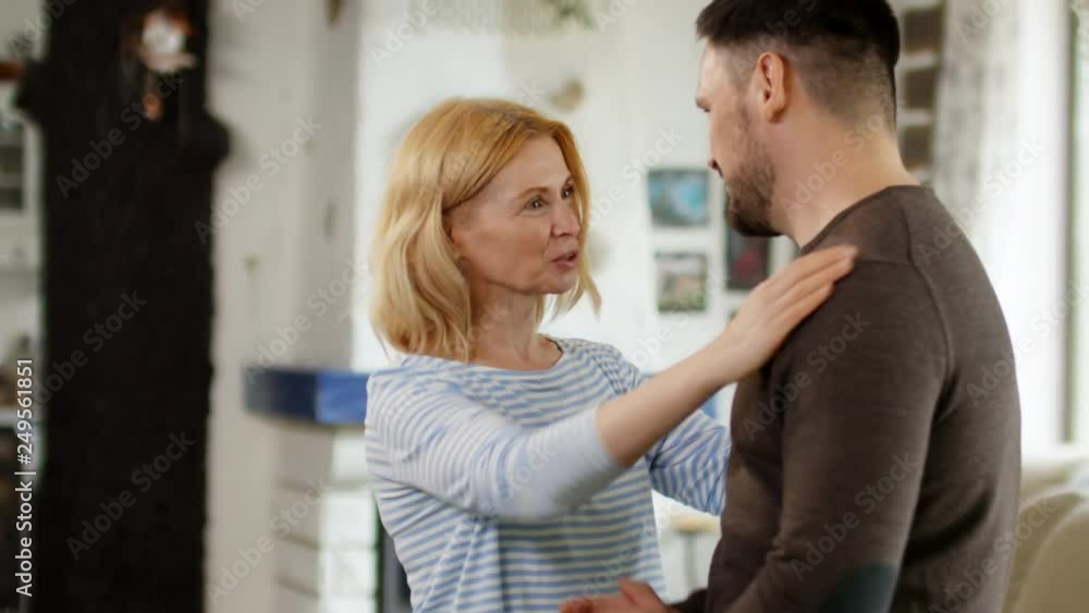 Medium shot of middle-aged Caucasian man and middle-aged Caucasian woman paying compliments to each other Medium shot of middle-aged Caucasian man and middle-aged Caucasian woman paying compliments to each other