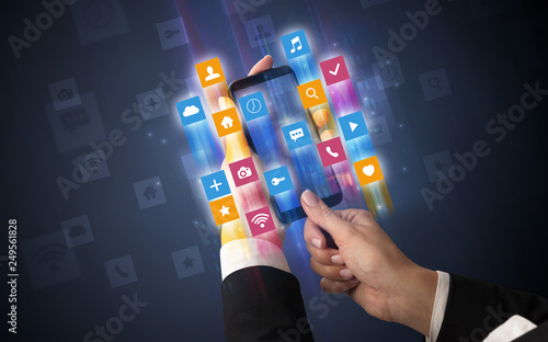 Female hand using smartphone with colorful angular fast switching application icons around photo