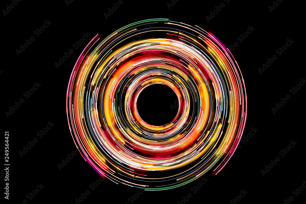 Abstract neon circle lines with empty copy space inside isolated on black background. Colorful led lights long exposure rotation photo.  - obrazy, fototapety, plakaty 