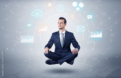 Elegant calm businessman levitates in yoga position with data circulation concept 