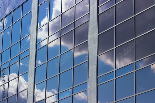 sky reflection in the windows of an office building