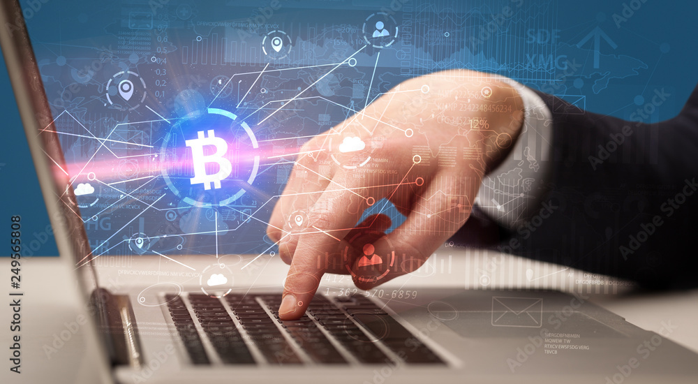 Hand checking on laptop global bitcoin exchange rate concept
Hand checking on laptop global bitcoin exchange rate concept