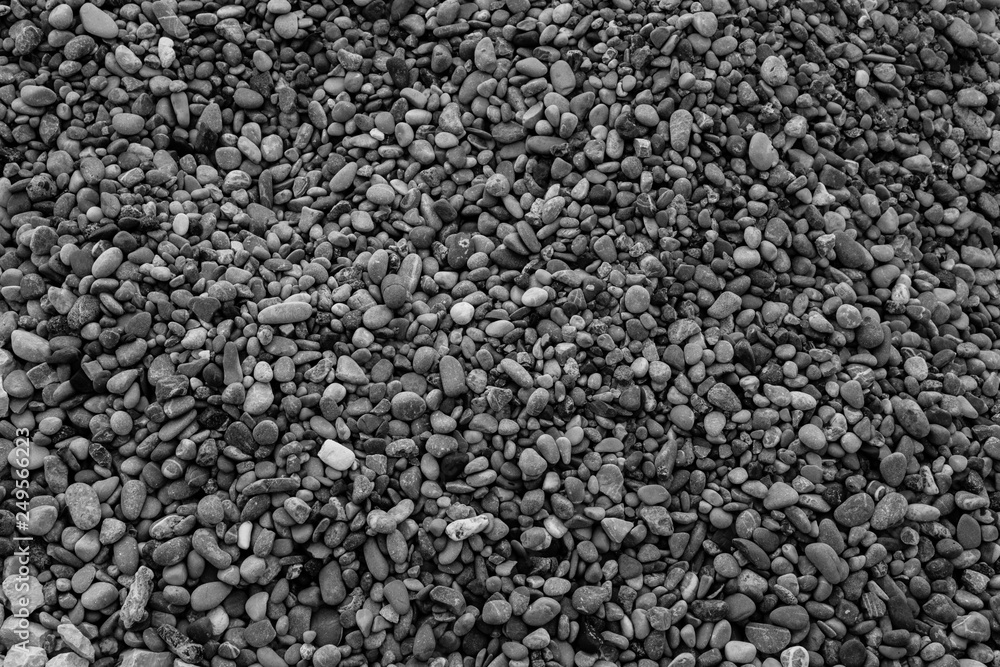 Black and white background of small and large gravel. Stone background for post, screensaver, wallpaper, postcard, poster, banner, cover, header for website. High quality photography Black and white background of small and large gravel. Stone background for post, screensaver, wallpaper, postcard, poster, banner, cover, header for website. High quality photography