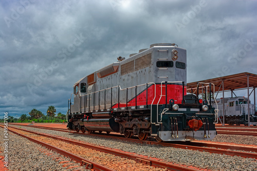 Freight diesel locomotive parked on train tracks at the end of the railway line in Guinea, Africa.