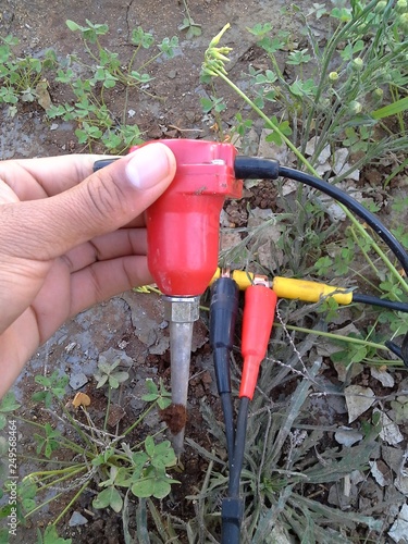  geo-physical  geophone  : ,Close up image of hand holding  geophone for seismic acquisition in hydrocarbons  exploration industry and engineering 