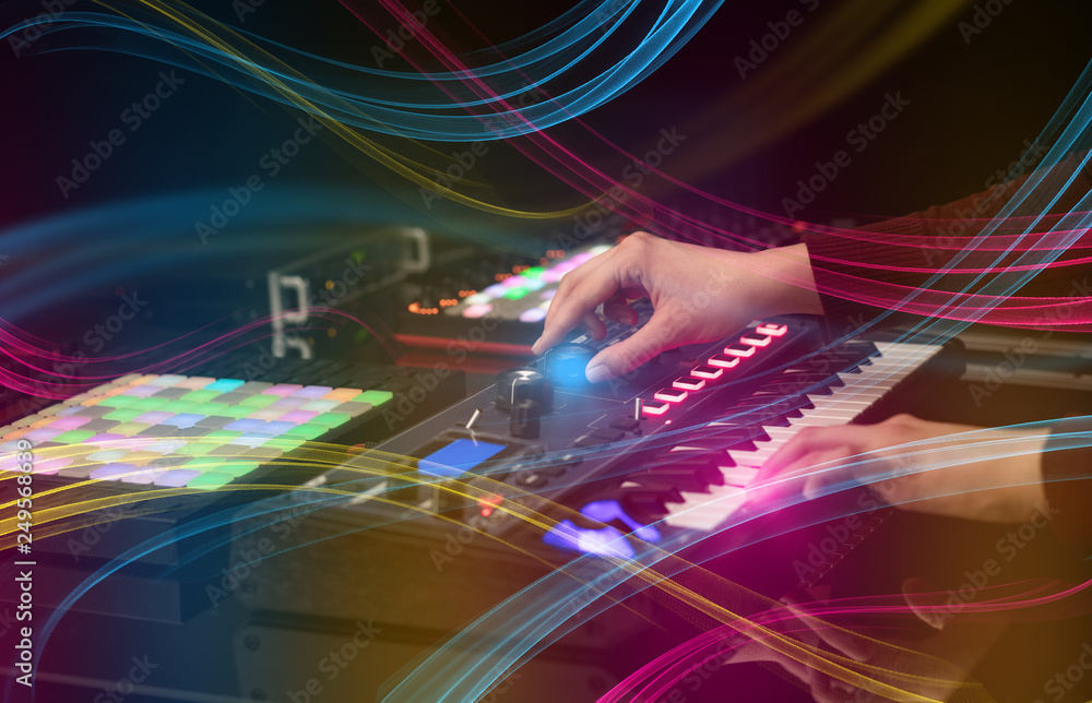 Hand mixing music on midi controller with colorful vibe concept
