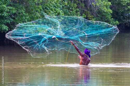 Canvas Print Fisherman fishing with net. Sri Lanka.