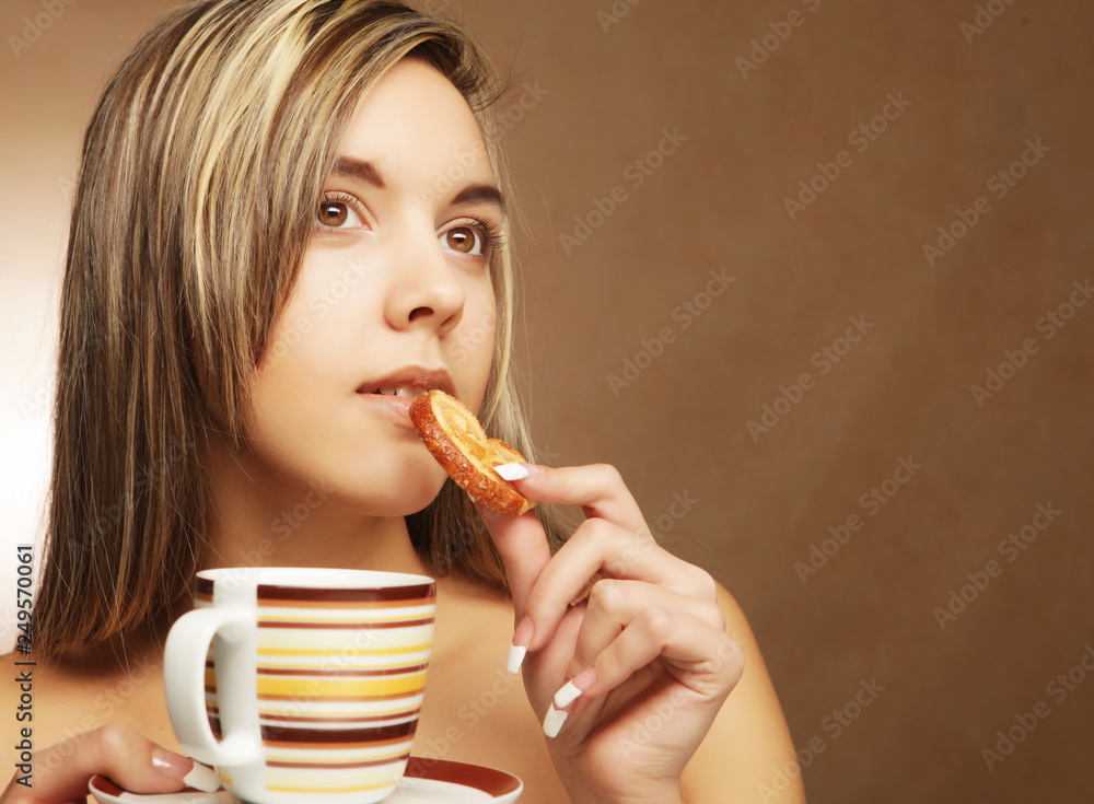lifestyle, people and food concept: young woman with coffee and cookies lifestyle, people and food concept: young woman with coffee and cookies