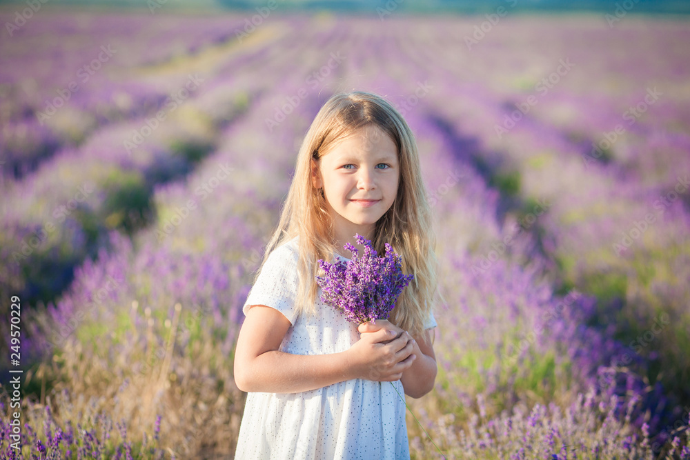 Portrait of a beautiful girl in a white dress with a bouquet of lavender Portrait of a beautiful girl in a white dress with a bouquet of lavender