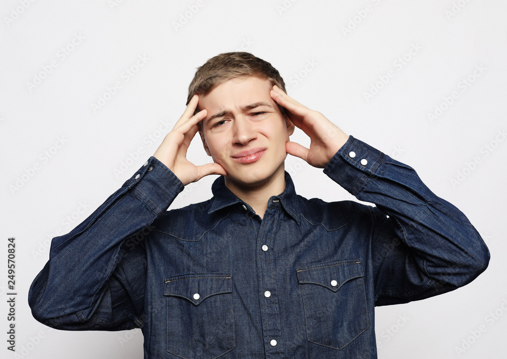 Handsome young man suffering from headache Handsome young man suffering from headache