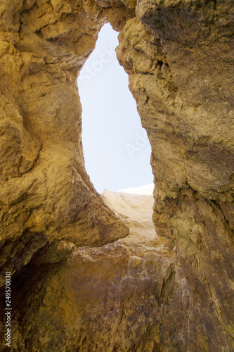 Hole in the rock on the beach. Algarve. Portugal