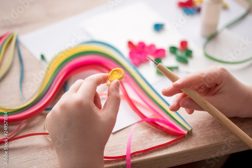 Quilling technique. Making decorations or greeting card. Paper strips, flower, scissors. Handmade crafts on holiday: Birthday, Mother's or Father's Day, March 8, Wedding. Children's DIY concept.