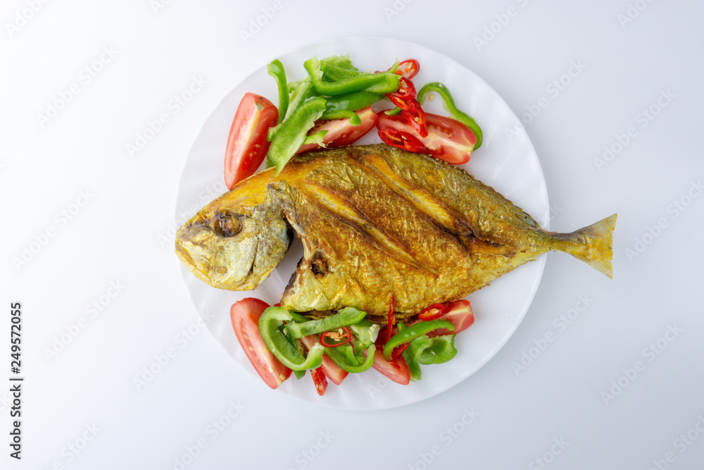 Fried fish on white background with selective focus and crop fragment Fried fish on white background with selective focus and crop fragment