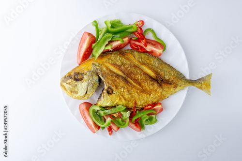 Fried fish on white background with selective focus and crop fragment