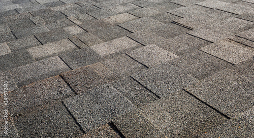 Layer of black graphite bitumen roof tiles