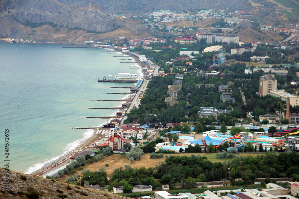 panorama bird eye view from the top to small town Sudak with colorful houses in valley in Crimea