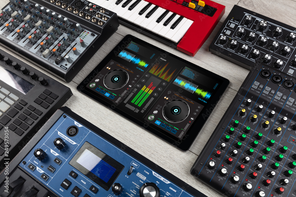 Mixing music on tablet with electronic music instruments concept
