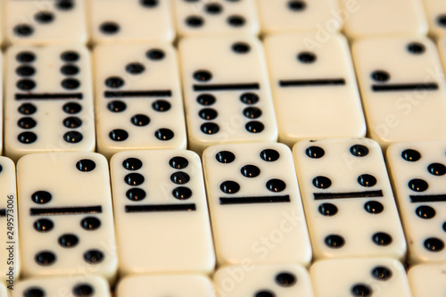 Various Dominos in a pattern lying down on a table
