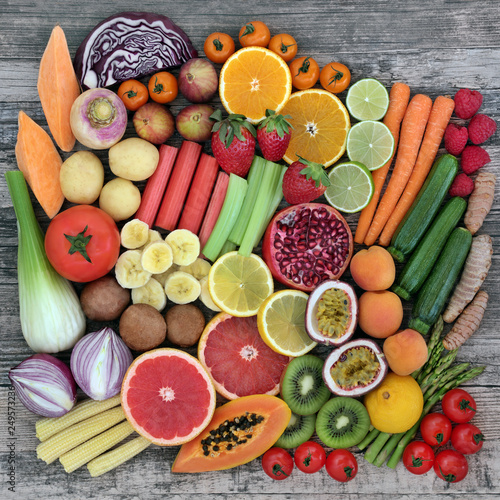 Diet super food selection with fresh vegetables and fruit with health food high in dietary fibre, antioxidants, vitamins and minerals. Top view on rustic wood background.