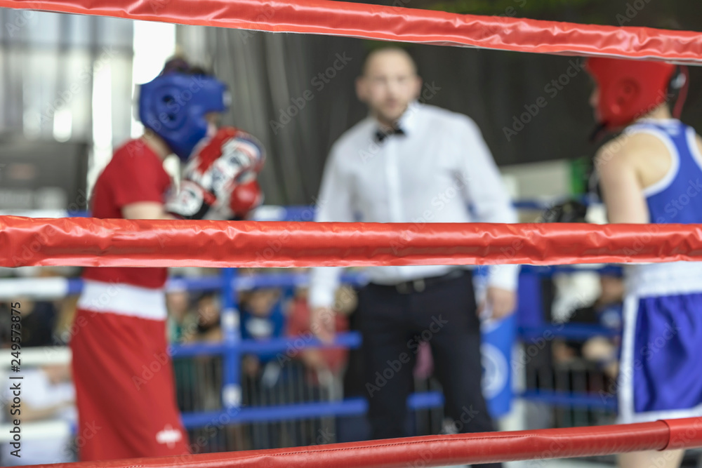 Blurred image young athletes boxers and sports referee in a ring boxing game - obrazy, fototapety, plakaty 