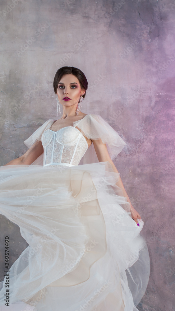 Beautiful and stylish bride in wedding dress with a lush flying skirt in Beautiful and stylish bride in wedding dress with a lush flying skirt in
