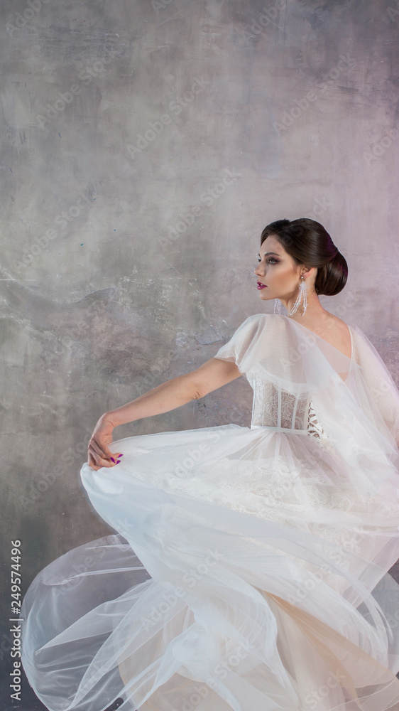 Beautiful and stylish bride in wedding dress with a lush flying skirt in Beautiful and stylish bride in wedding dress with a lush flying skirt in
