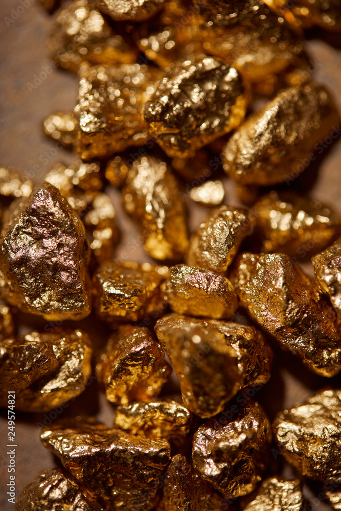 top view of golden stones on brown background top view of golden stones on brown background