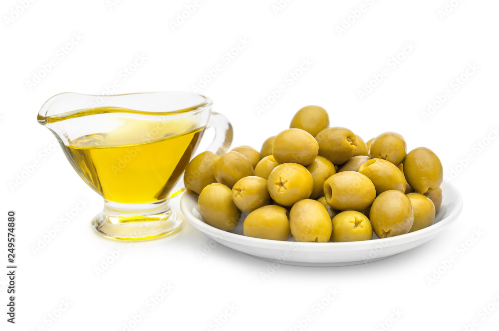 Saucer with green olives and gravy boat with olive oil on white. Saucer with green olives and gravy boat with olive oil on white.