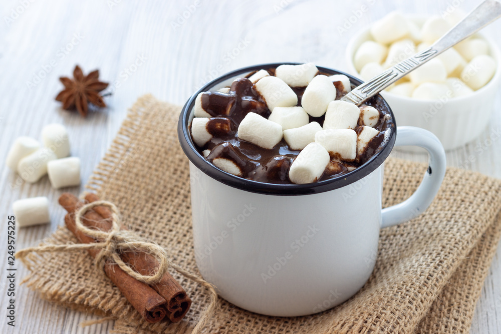 Hot chocolate with marshmallows in a white metal vintage mug Hot chocolate with marshmallows in a white metal vintage mug
