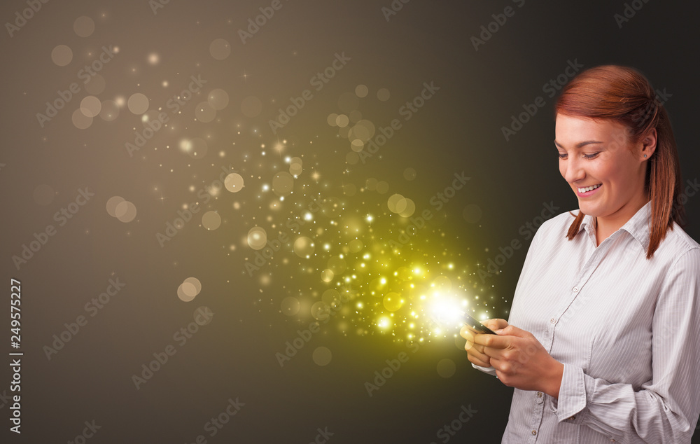 Person using phone with gold sparkling concept
Person using phone with gold sparkling concept