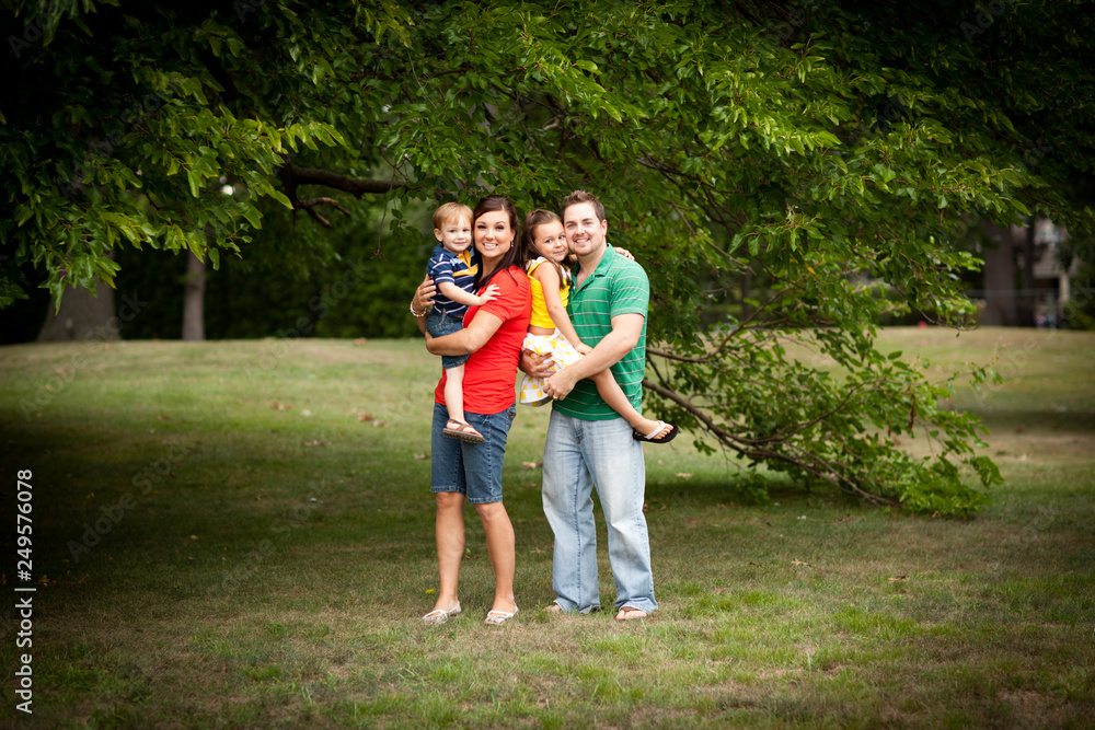 Obraz premium Happy Young Family Standing Together Outside