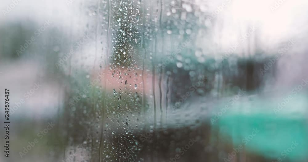 Raindrops on glass car window with road light bokeh. Royalty high-quality free stock footage of rain drops on car glass in rainy season. Closeup of water drop on the glass, car driving in rainy day Raindrops on glass car window with road light bokeh. Royalty high-quality free stock footage of rain drops on car glass in rainy season. Closeup of water drop on the glass, car driving in rainy day