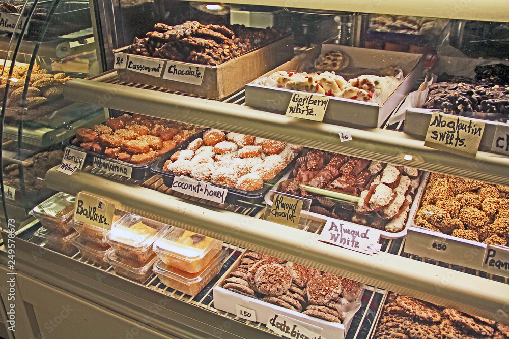 An assortment of baked goods displayed in a glass covered display case in a cafe shop in Mykonos Greece.