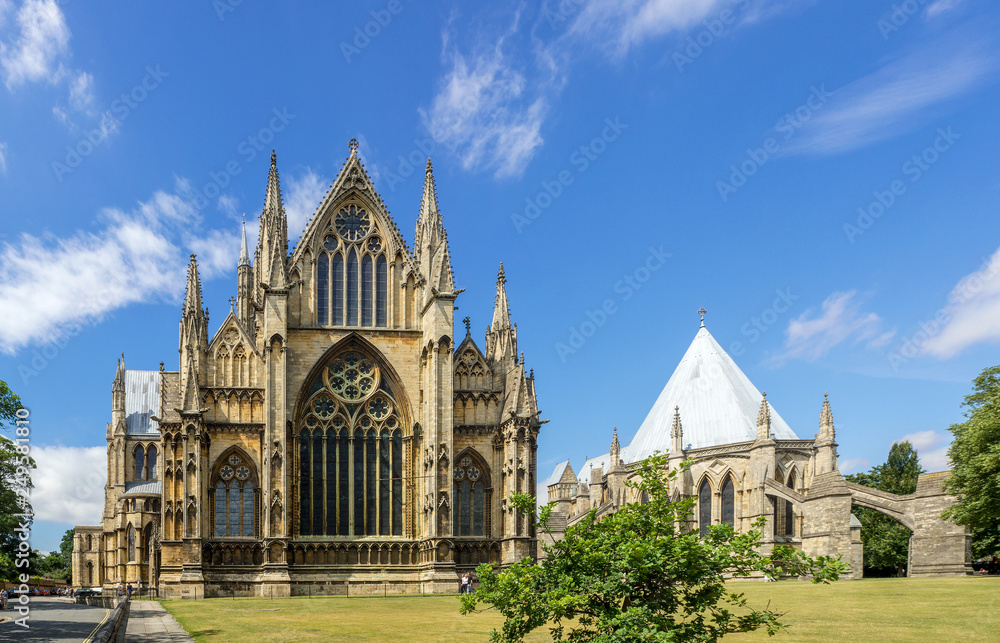 Gothic St Mary Cathedral in Lincoln, Lincolnshire, England, UK. Presbytery with rosettes and lancet windows with stained glass and chapter house with flying buttresses