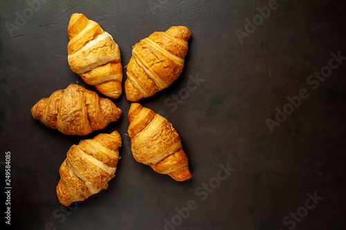 croissants on wooden cutting board  on background  stone  top view