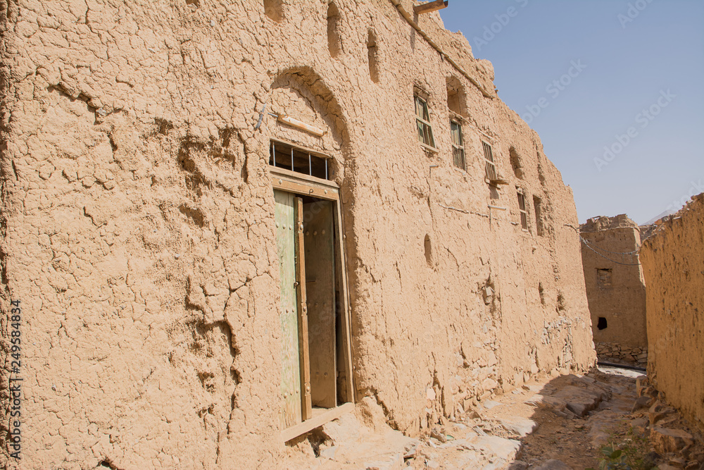 Alley between the mud houses of the old village of Al Hamra