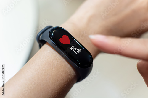 Fototapeta Naklejka Na Ścianę i Meble -  Close up image hand of male using smart watch with health app checking measure heart rate at normal levels