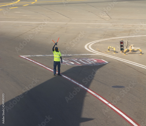 Land crew at the airport makes signs on the runway