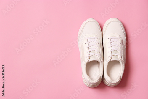women's sneakers on a colored background top view. Women's shoes.