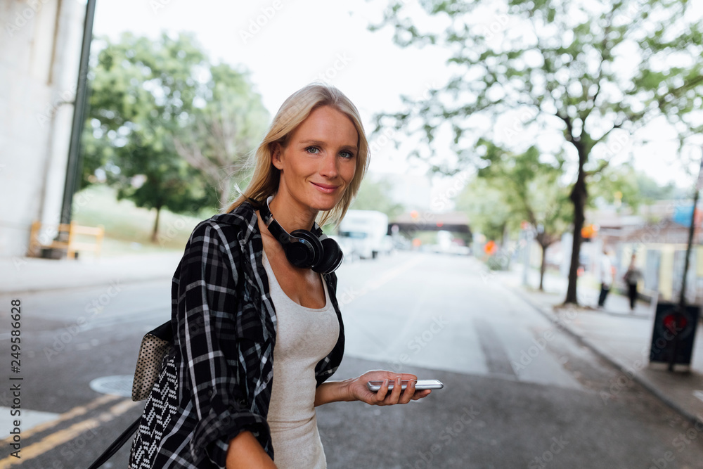 USA, New York City, Brooklyn, portrait of smiling young woman in the city on the go USA, New York City, Brooklyn, portrait of smiling young woman in the city on the go