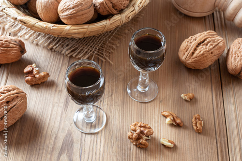 Homemade nut liqueur with walnuts on a table