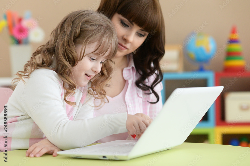 Portrait of cute girl using laptop at home Portrait of cute girl using laptop at home