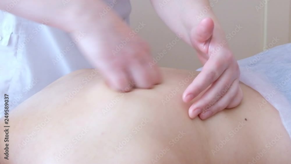 Close-up of the hands of a massage therapist on the back of the patient. SPA procedure. Close-up of the hands of a massage therapist on the back of the patient. SPA procedure.