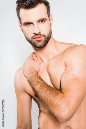 shirtless handsome bearded man posing isolated on grey